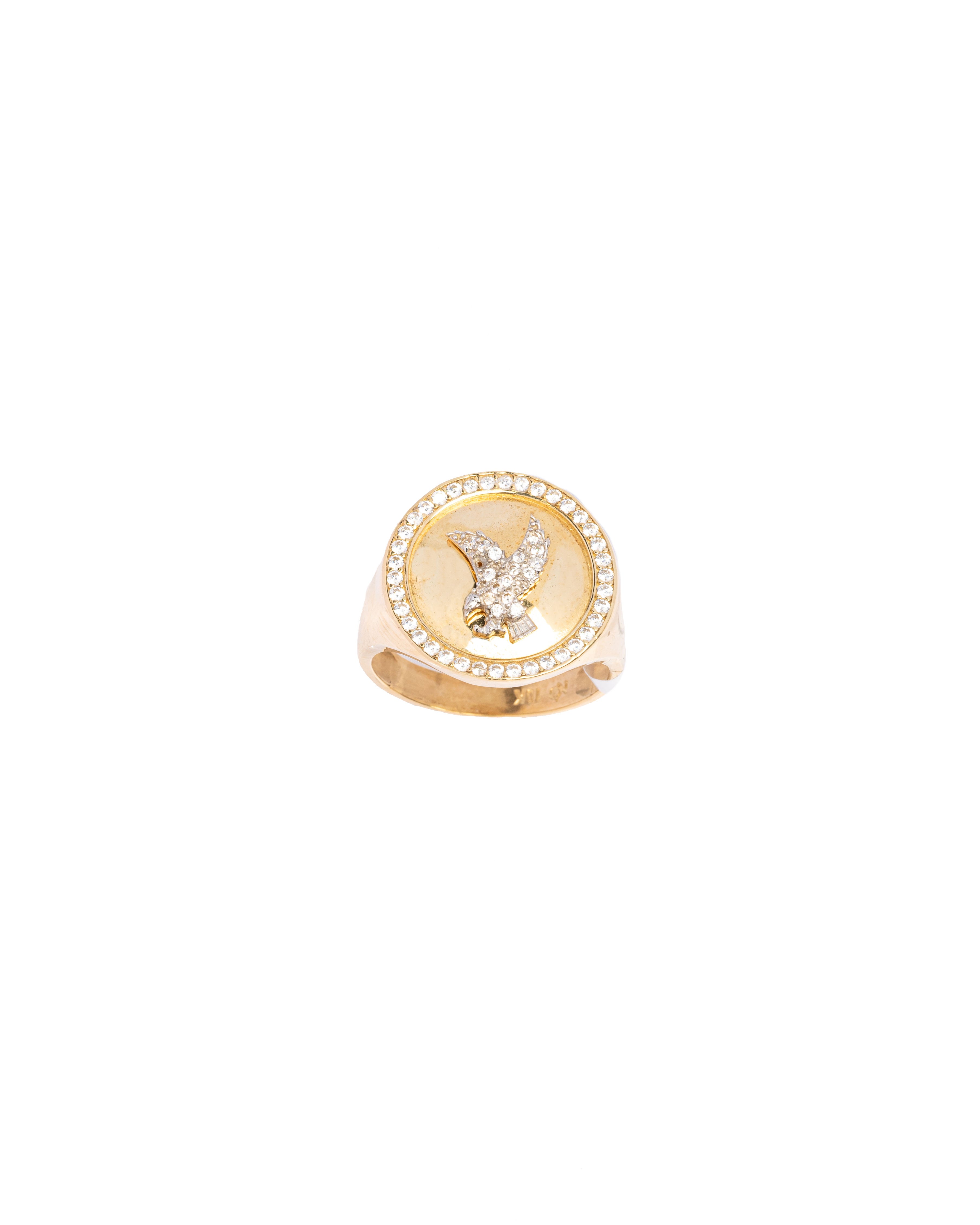 Gold ring with a central diamond on a white background