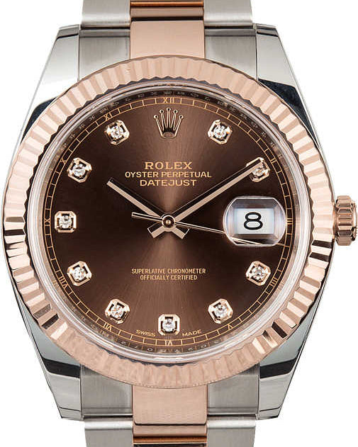 Luxury watch with rose gold and silver band on white background