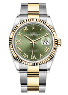 Luxury watch with green dial and gold and silver band on white background