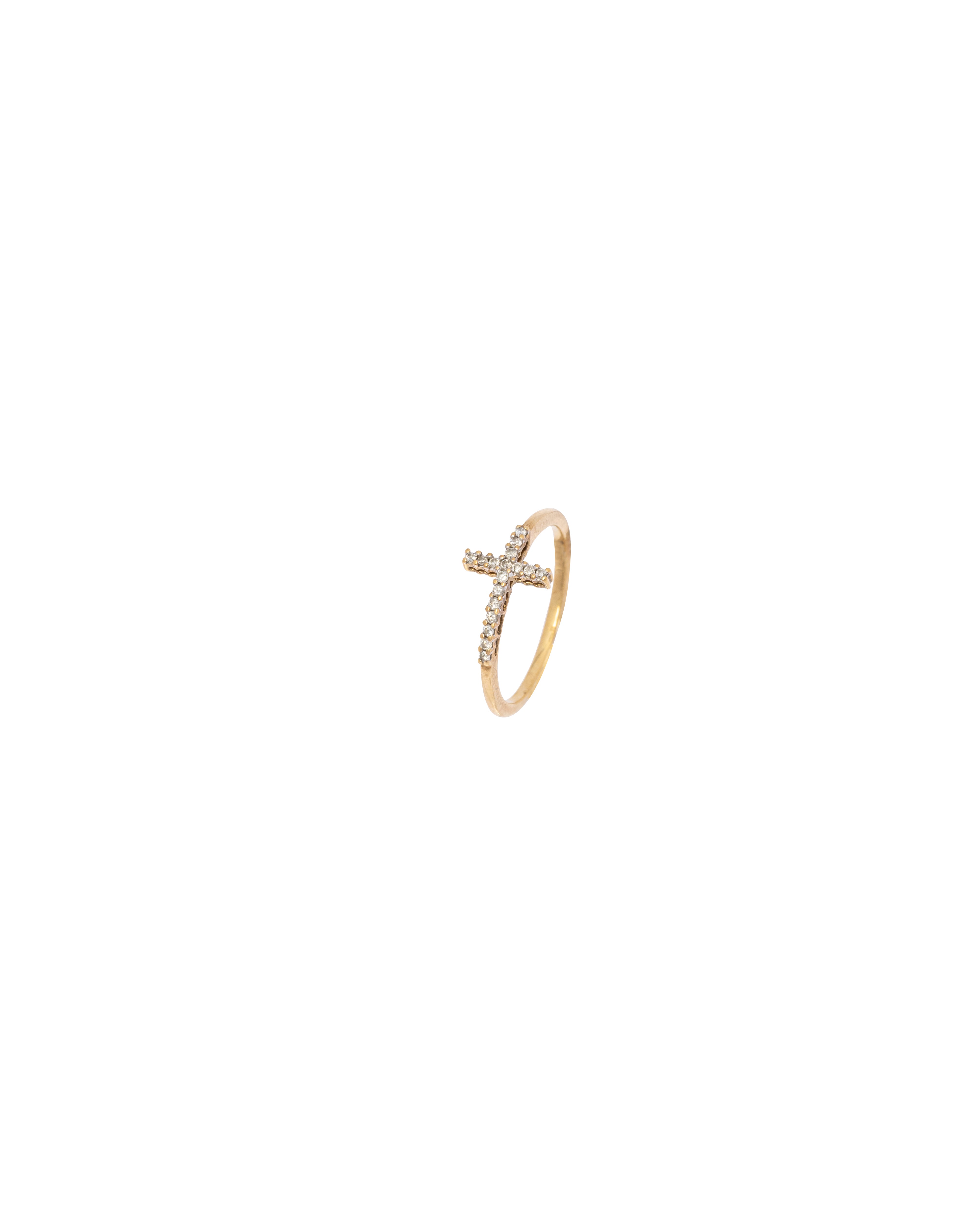 Gold ring with a cross design on a white background