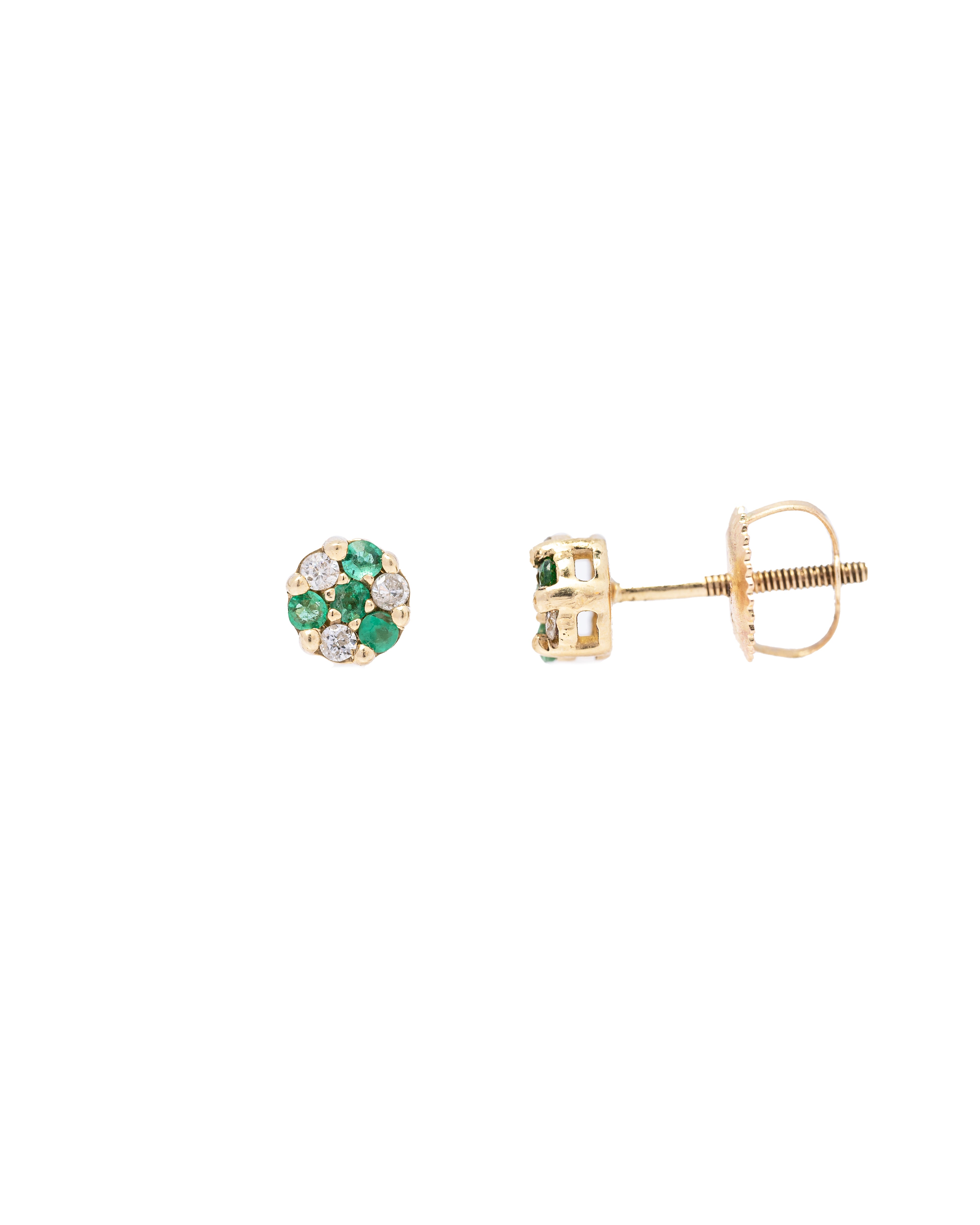 Gold earrings with green gemstones on a white background