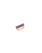 Gold ring with purple gemstones on a white background