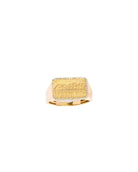 Gold ring with engraved design on a white background
