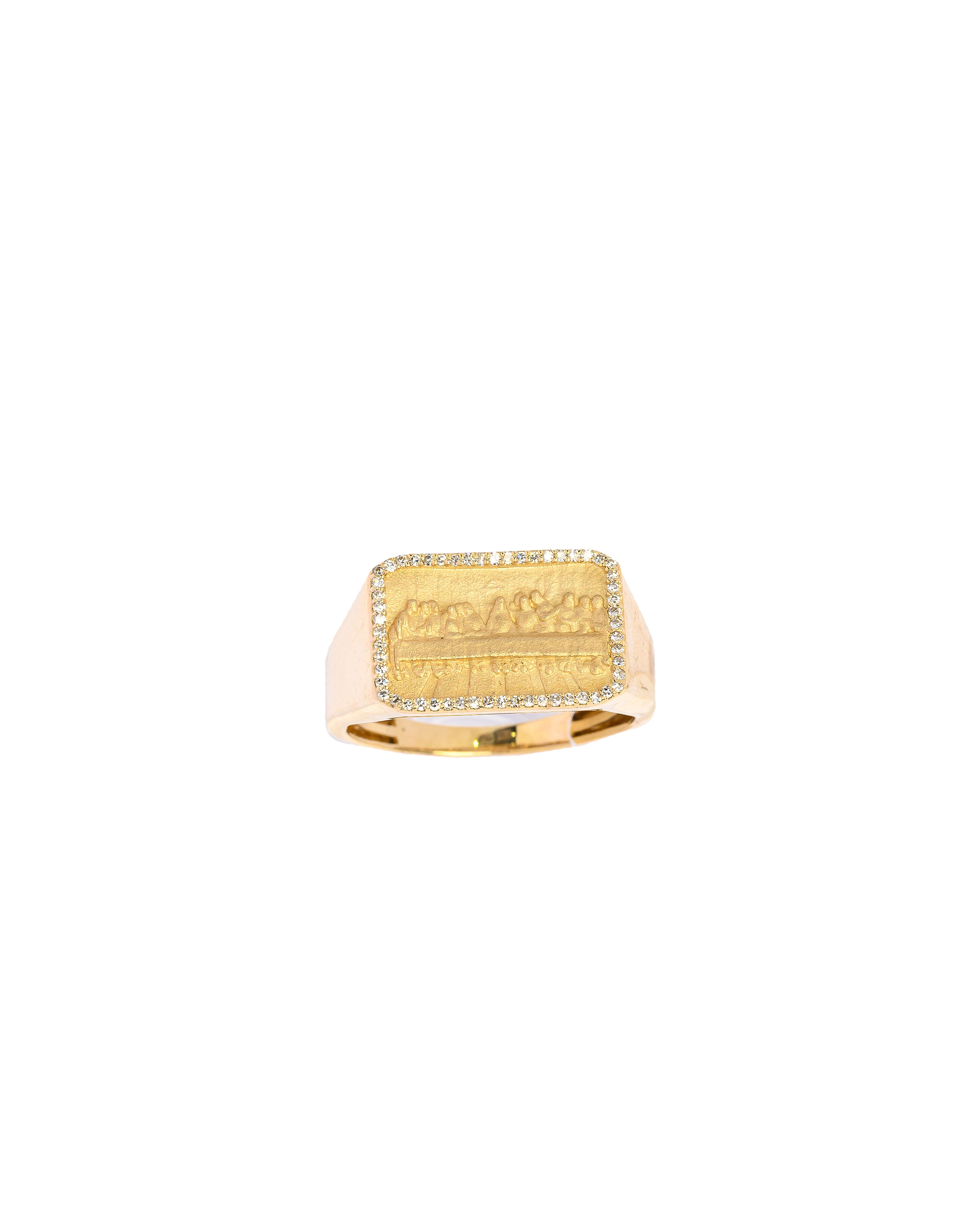 Gold ring with engraved design on a white background