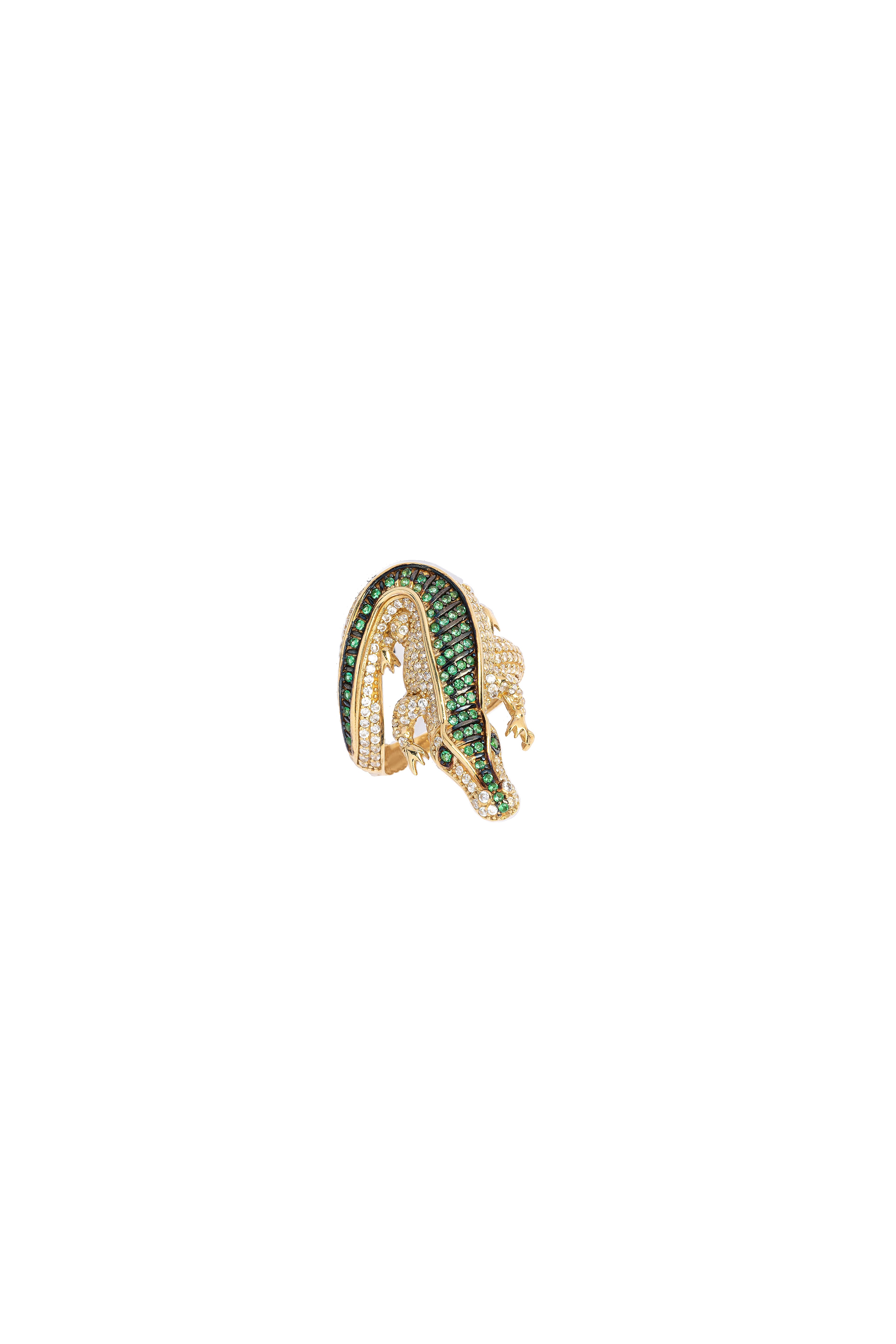 Gold earring with green gemstones on a white background