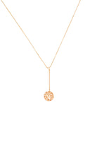 Gold necklace with a round pendant on a white background