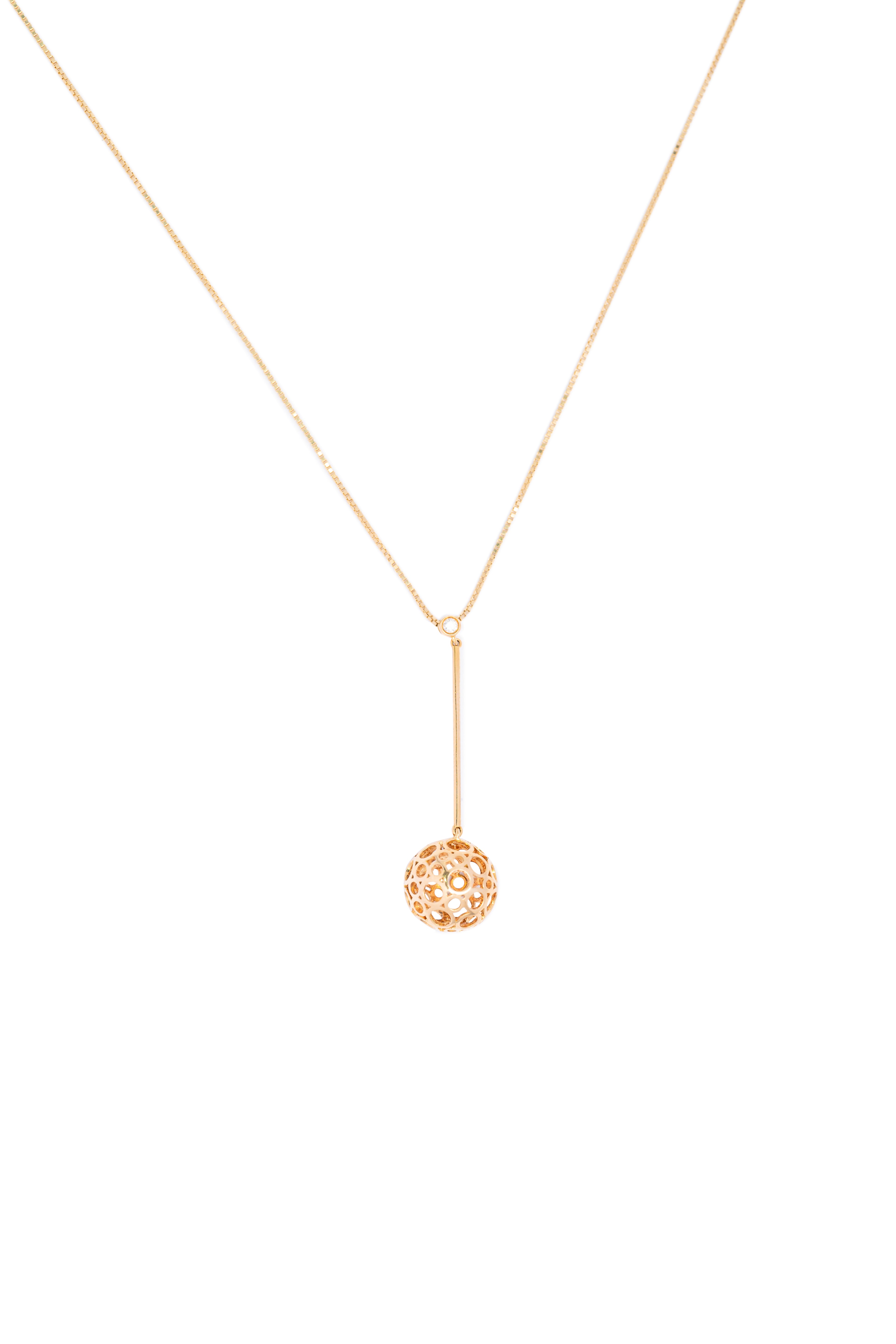 Gold necklace with a round pendant on a white background