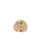 Gold ring with intricate design on a white background