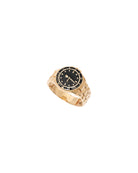 Gold ring with a black dial on a white background
