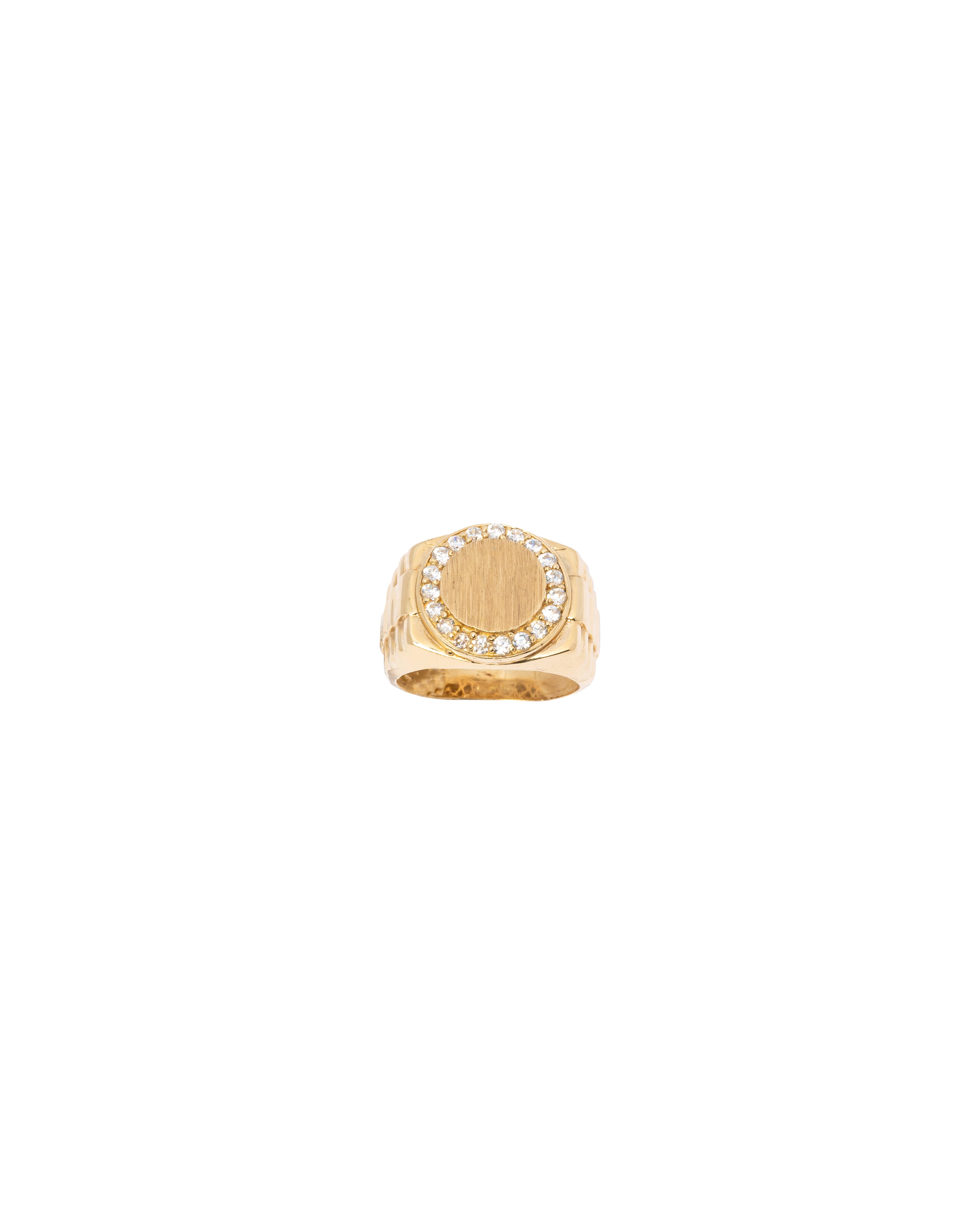 Gold ring with a circular design on a white background