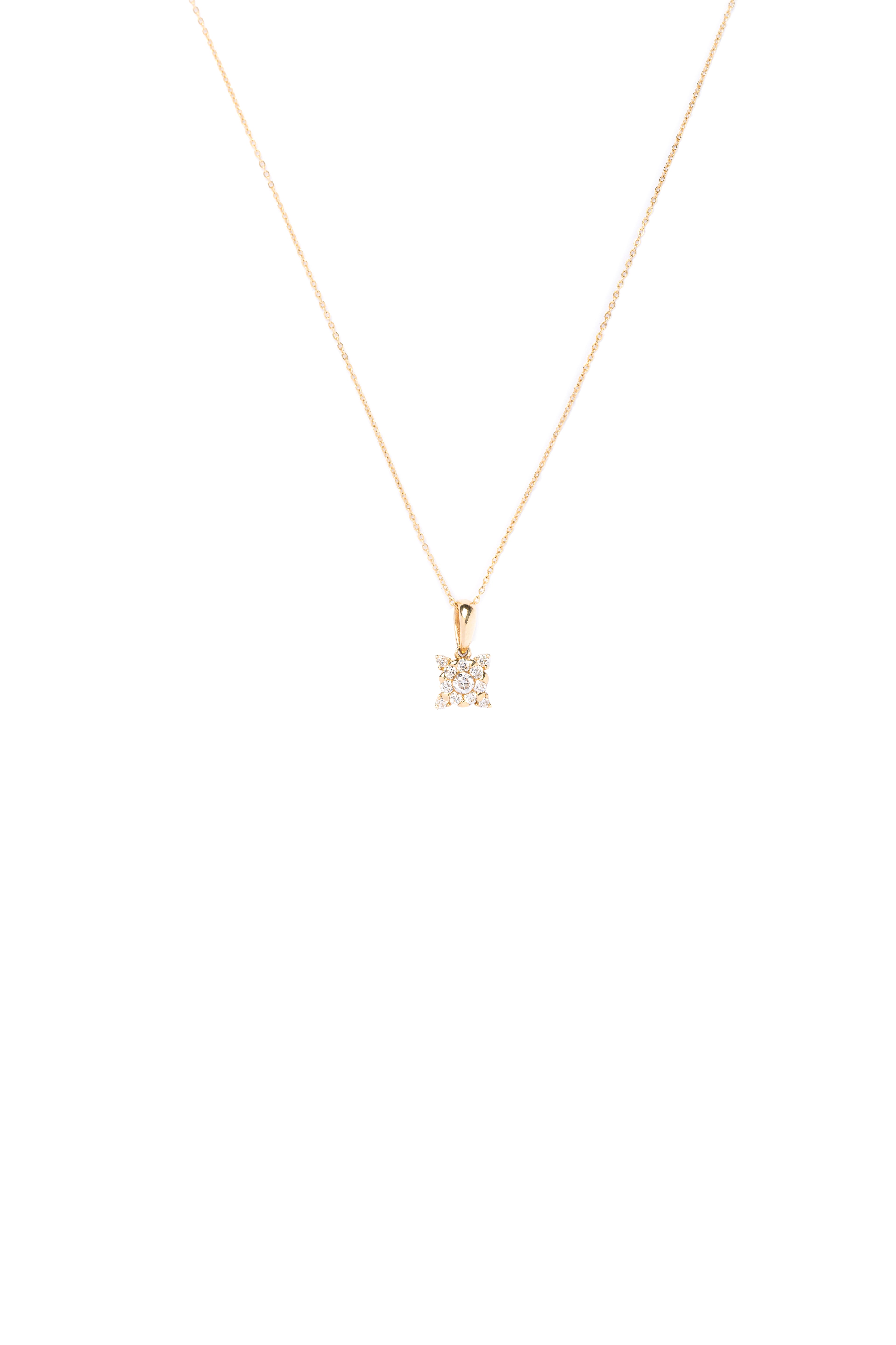 Gold necklace with a diamond pendant on a white background
