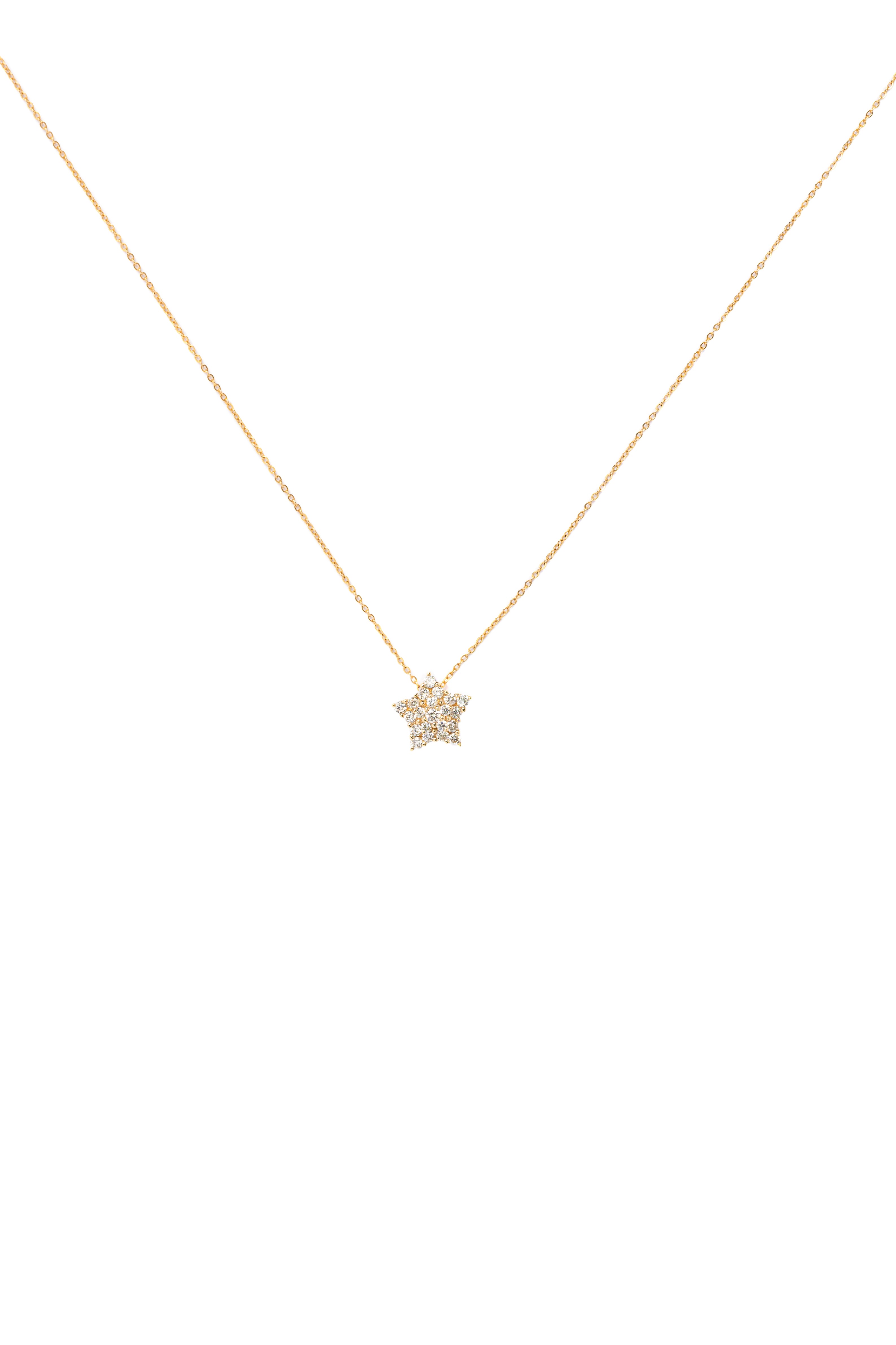 Gold necklace with a star-shaped pendant on a white background