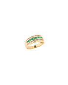 Gold ring with green gemstones on a white background
