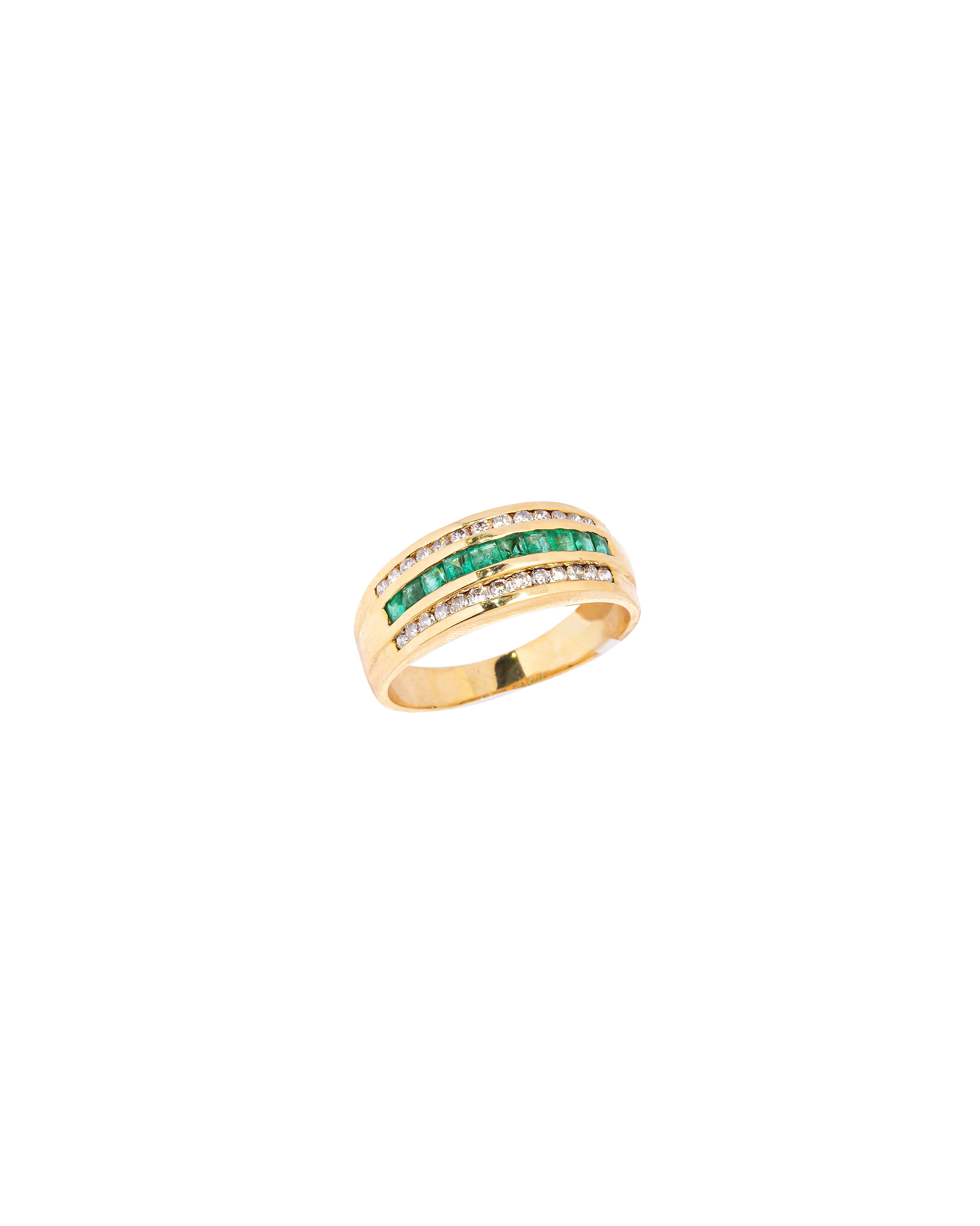 Gold ring with green gemstones on a white background