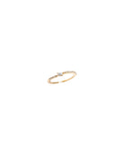 Gold bracelet with a small diamond on a white background