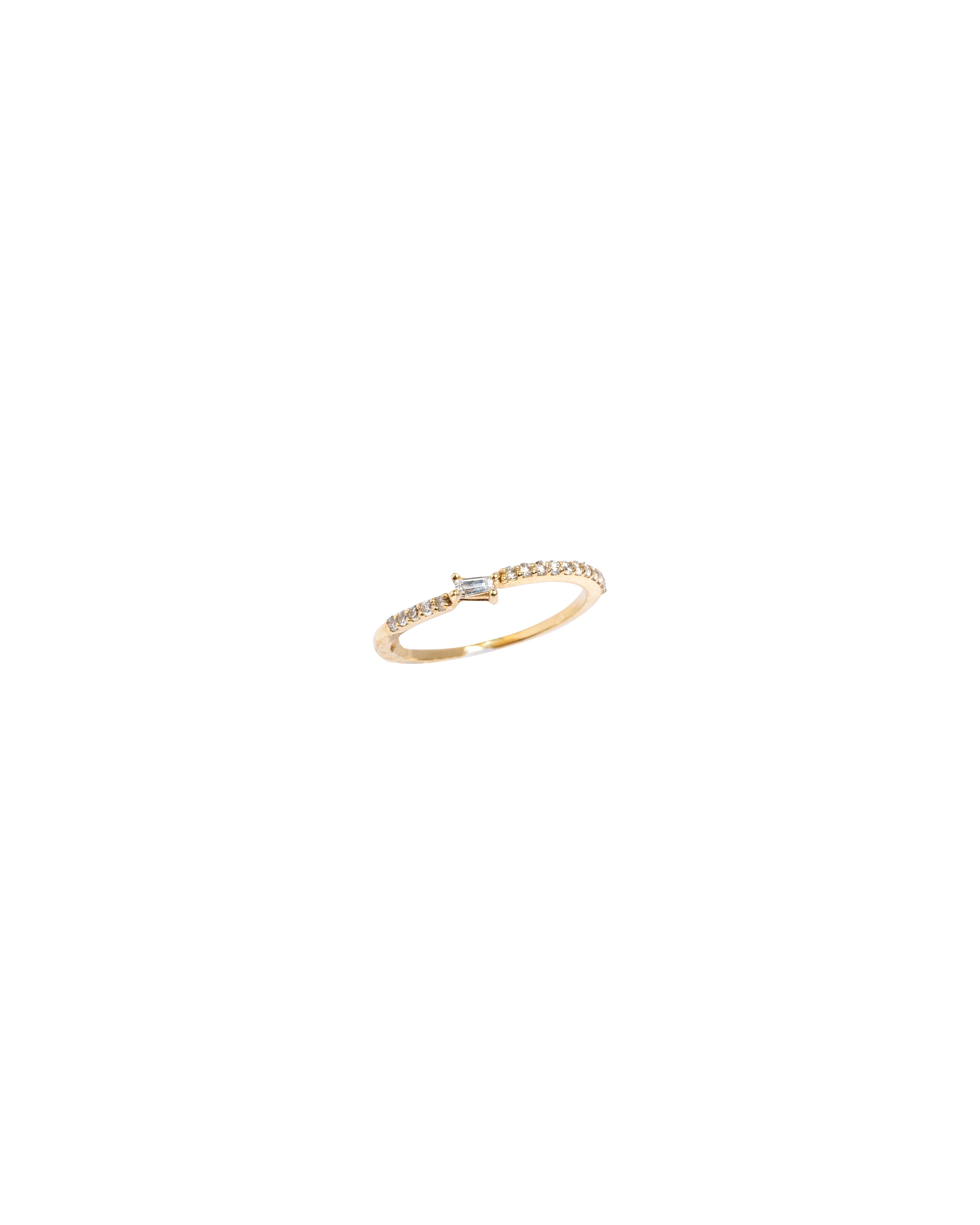 Gold bracelet with a small diamond on a white background