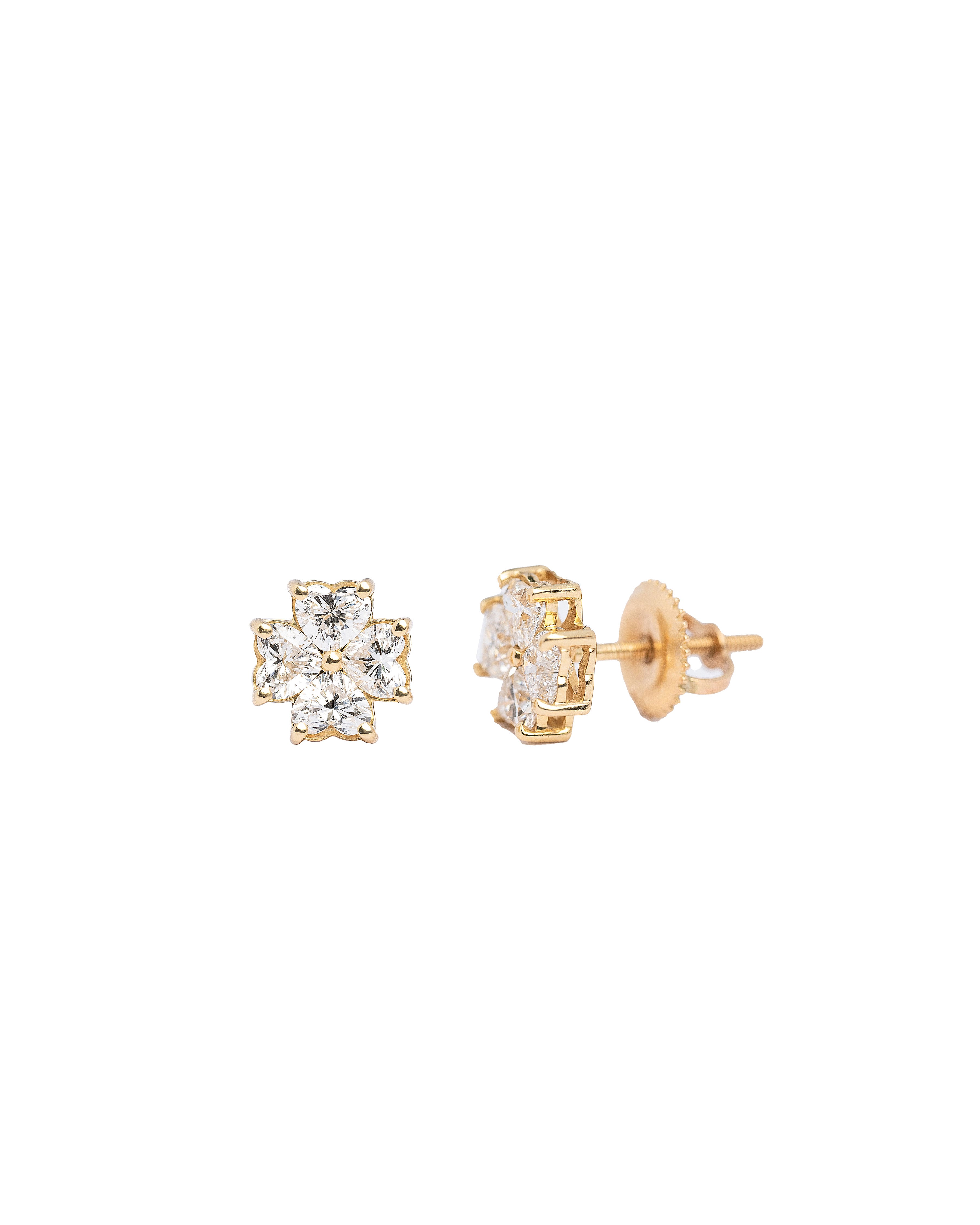 Pair of gold earrings with diamond-like stones on a white background