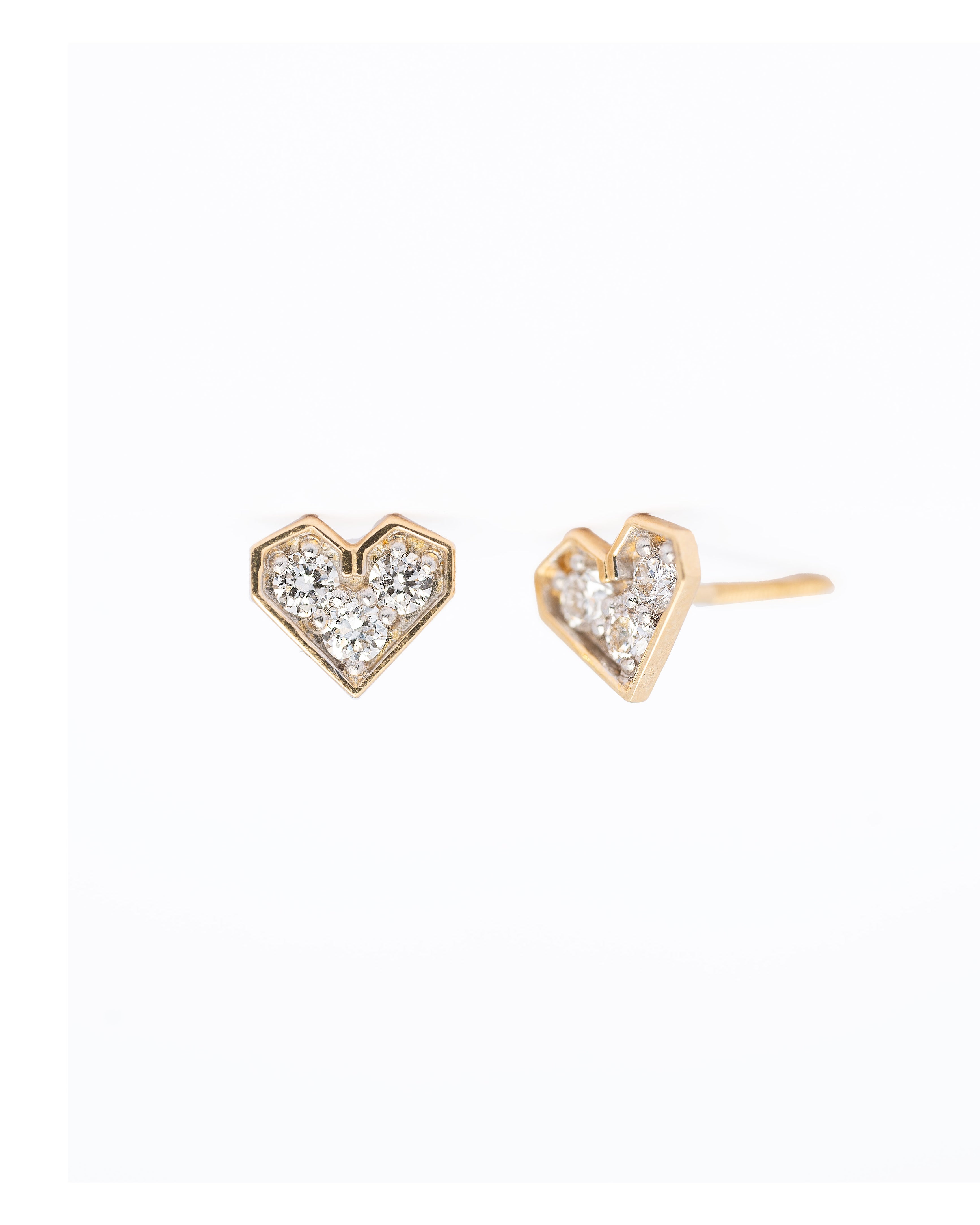 Heart-shaped earrings with diamond accents on a white background