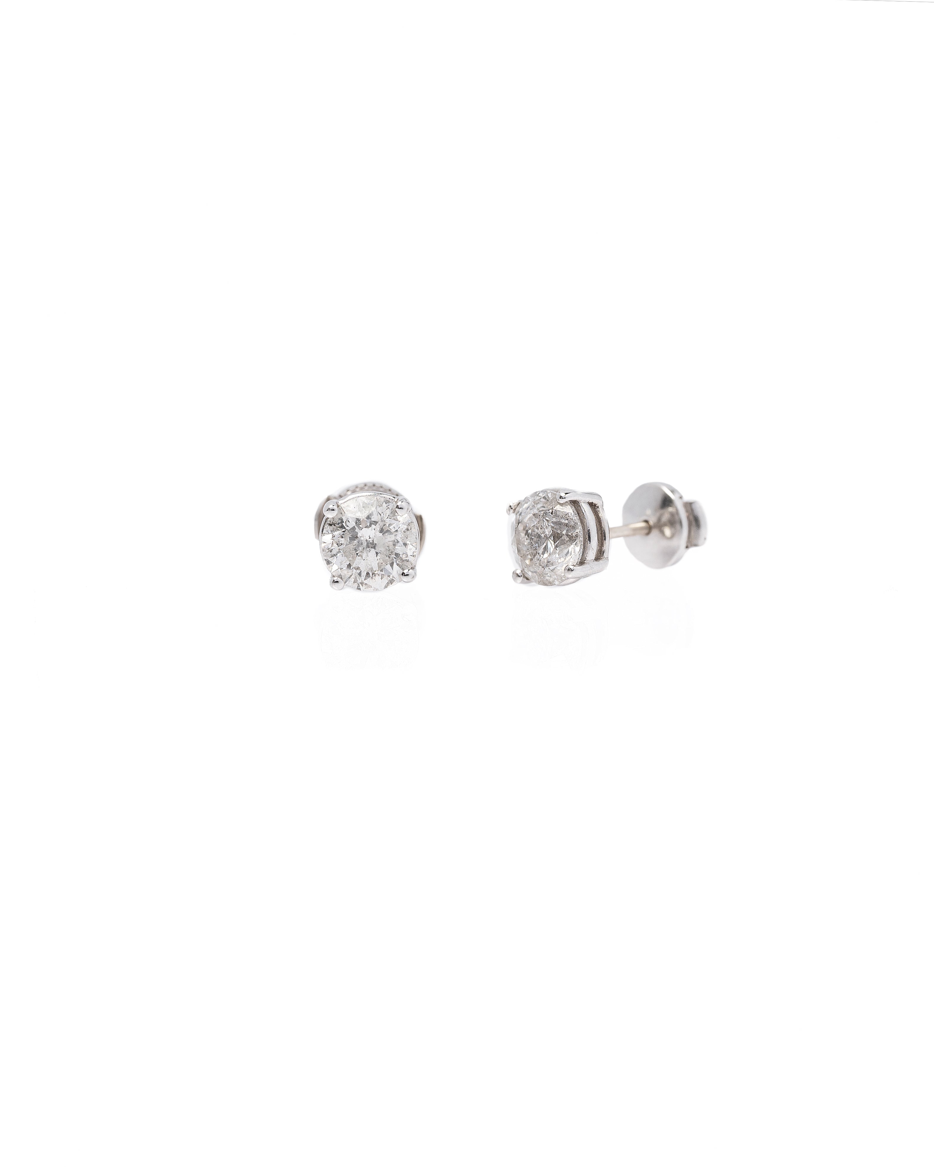 Pair of diamond stud earrings on a white background