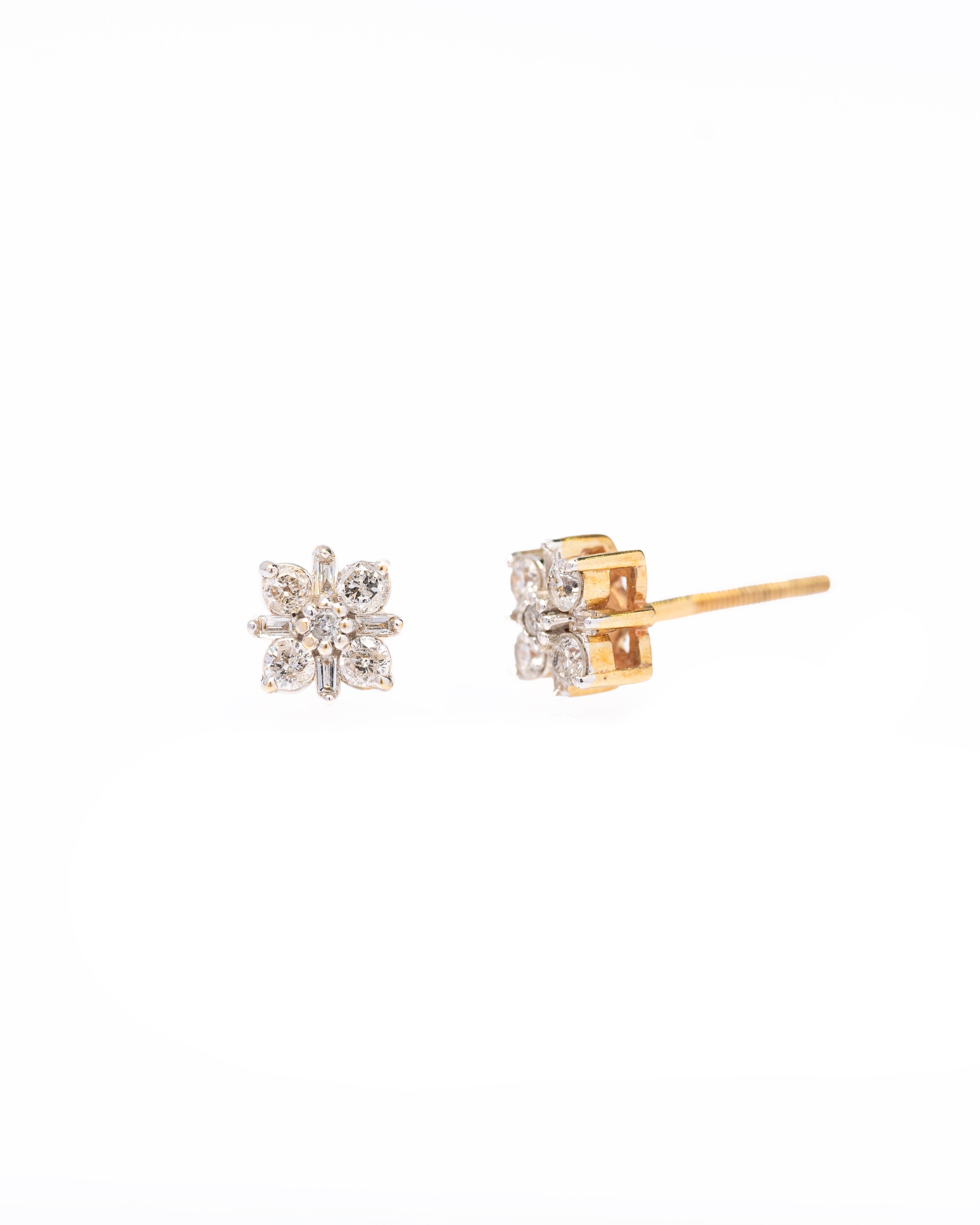 Pair of gold and silver snowflake earrings on a white background
