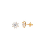 Gold earrings with diamond-like stones on a white background