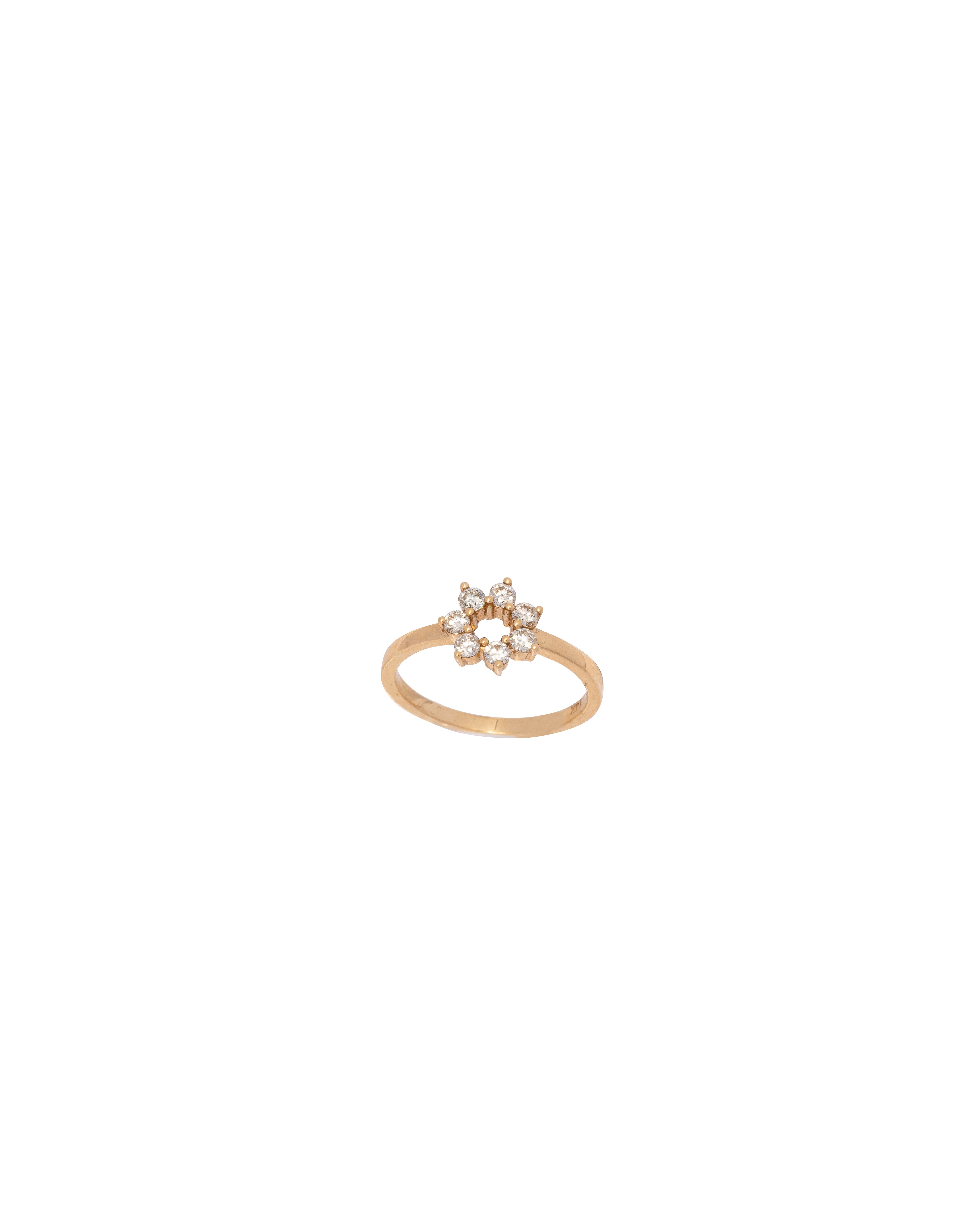 Gold ring with a star design on a white background