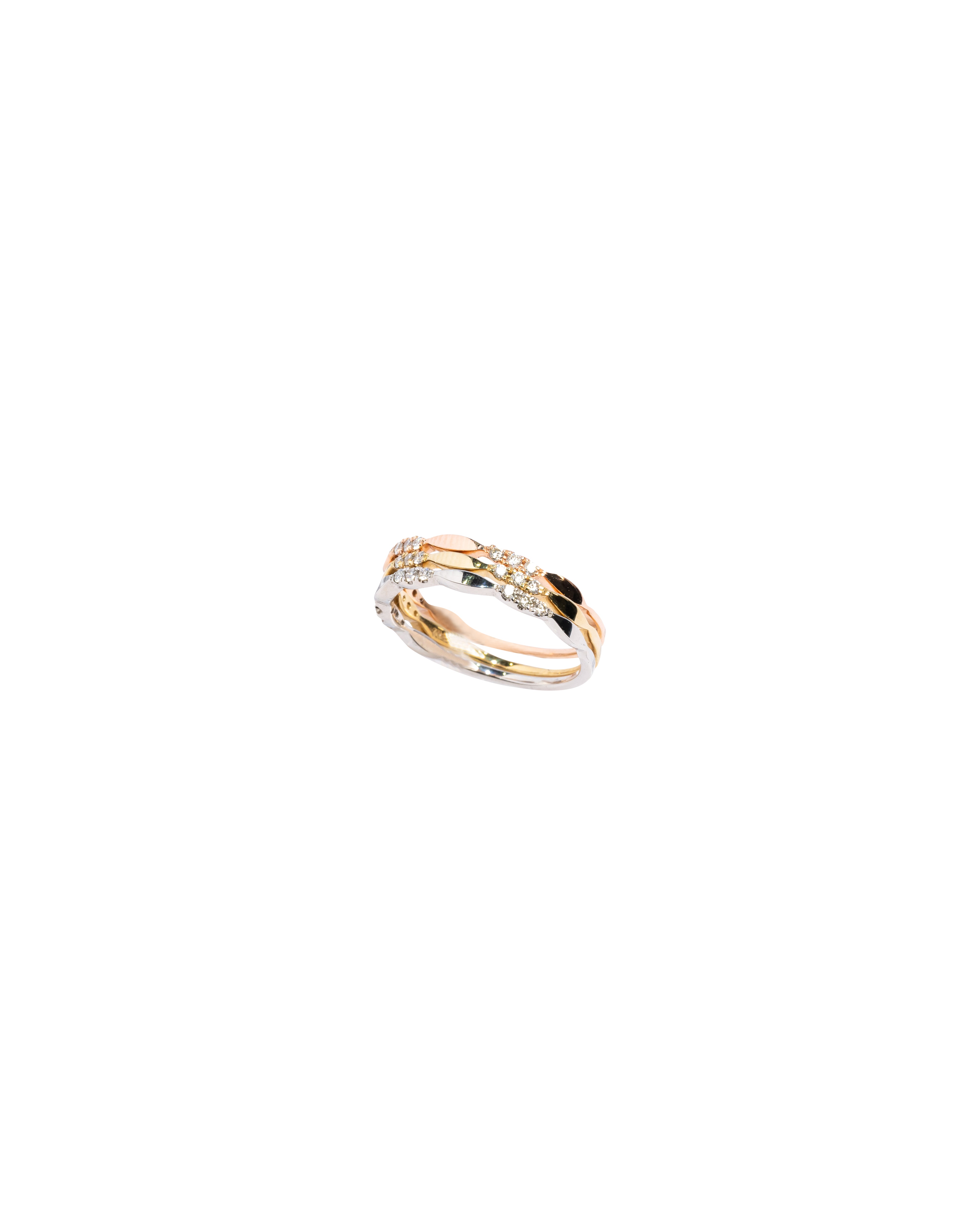 Two gold rings stacked on a white background