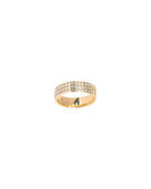 Gold ring with embedded stones on a white background