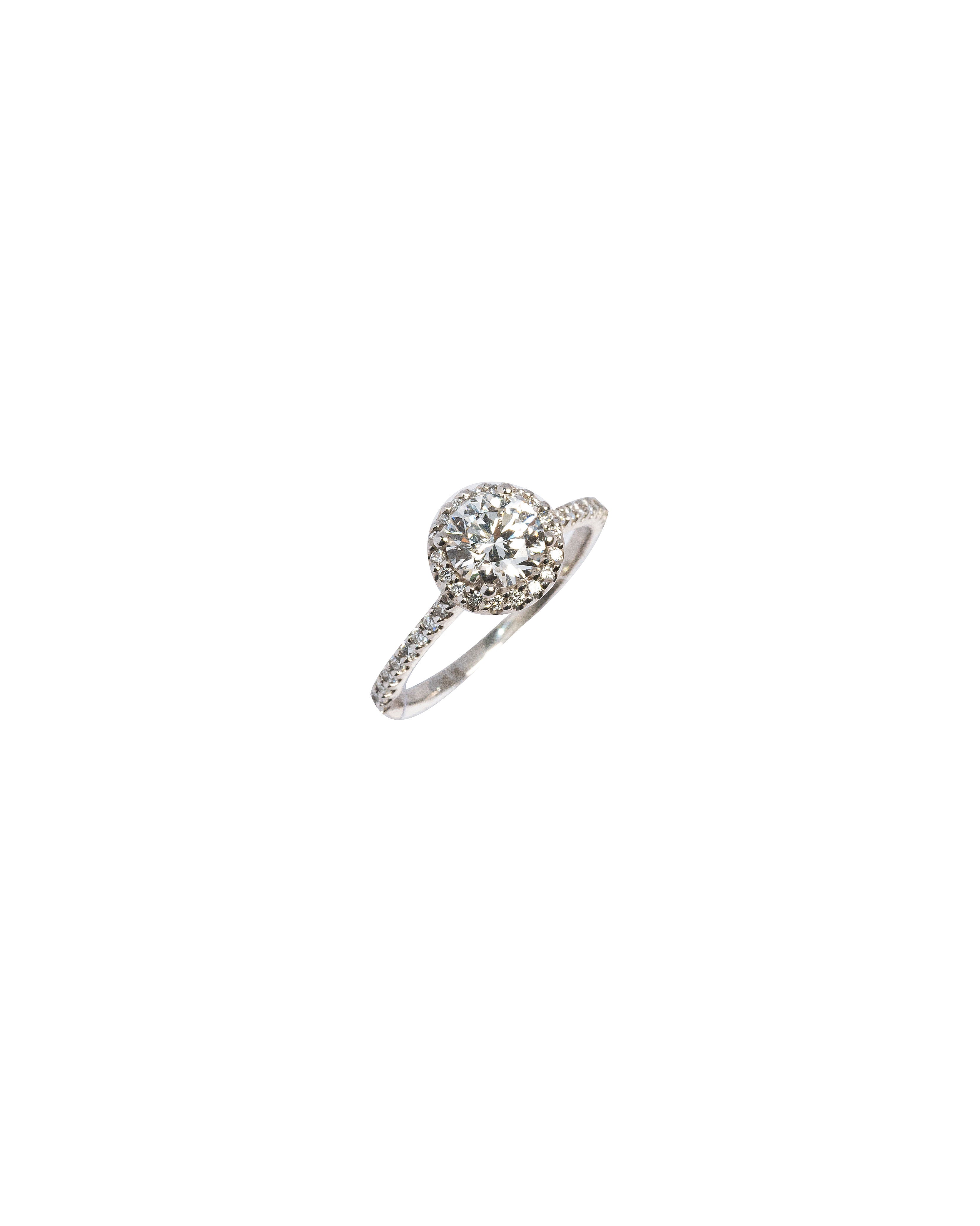 Silver ring with a diamond on a white background