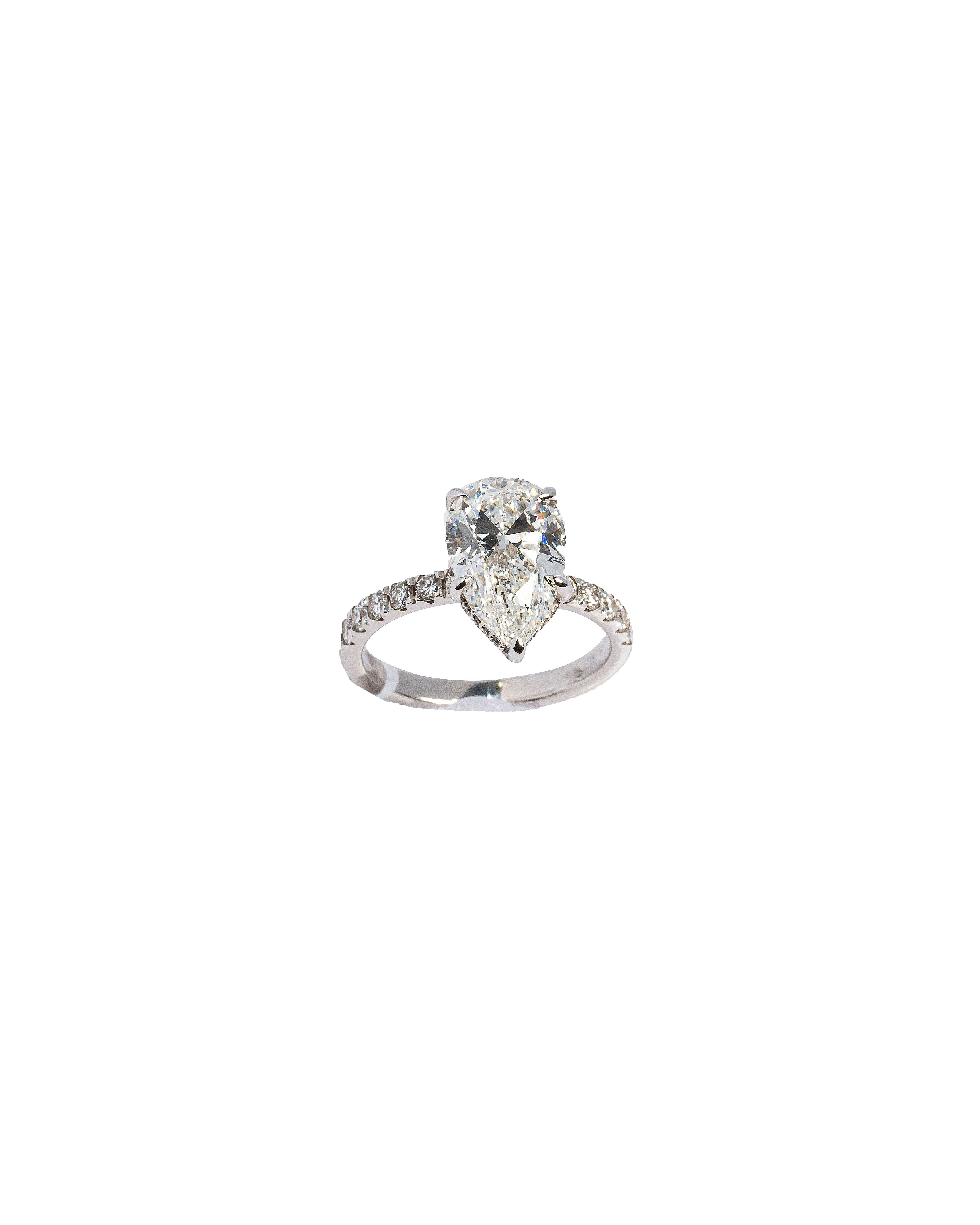 Diamond ring with a heart-shaped center stone on a white background