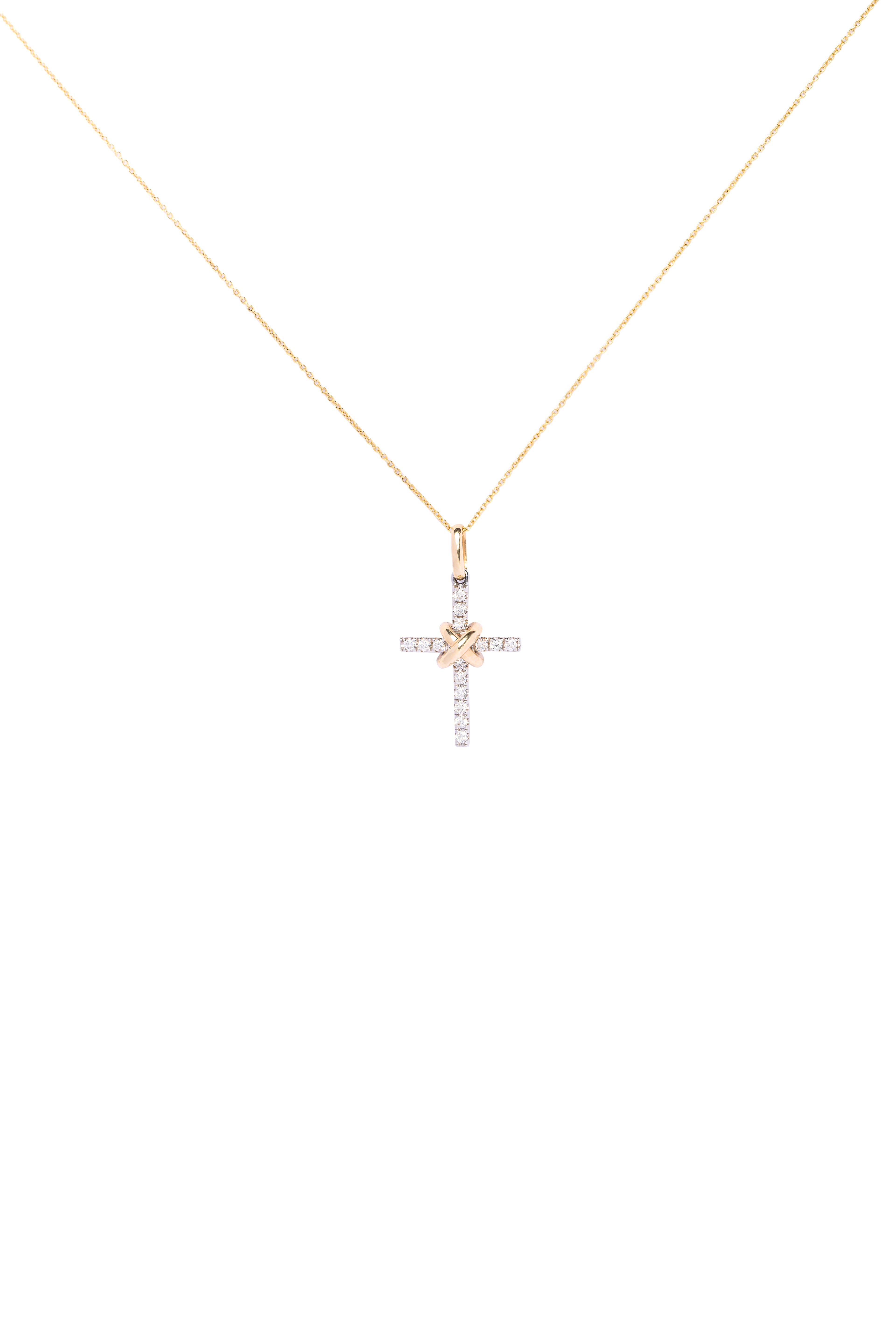 Gold necklace with a cross pendant on a white background