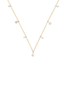 Gold necklace with small pearls on a white background