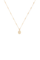 Gold necklace with a small pendant on a white background