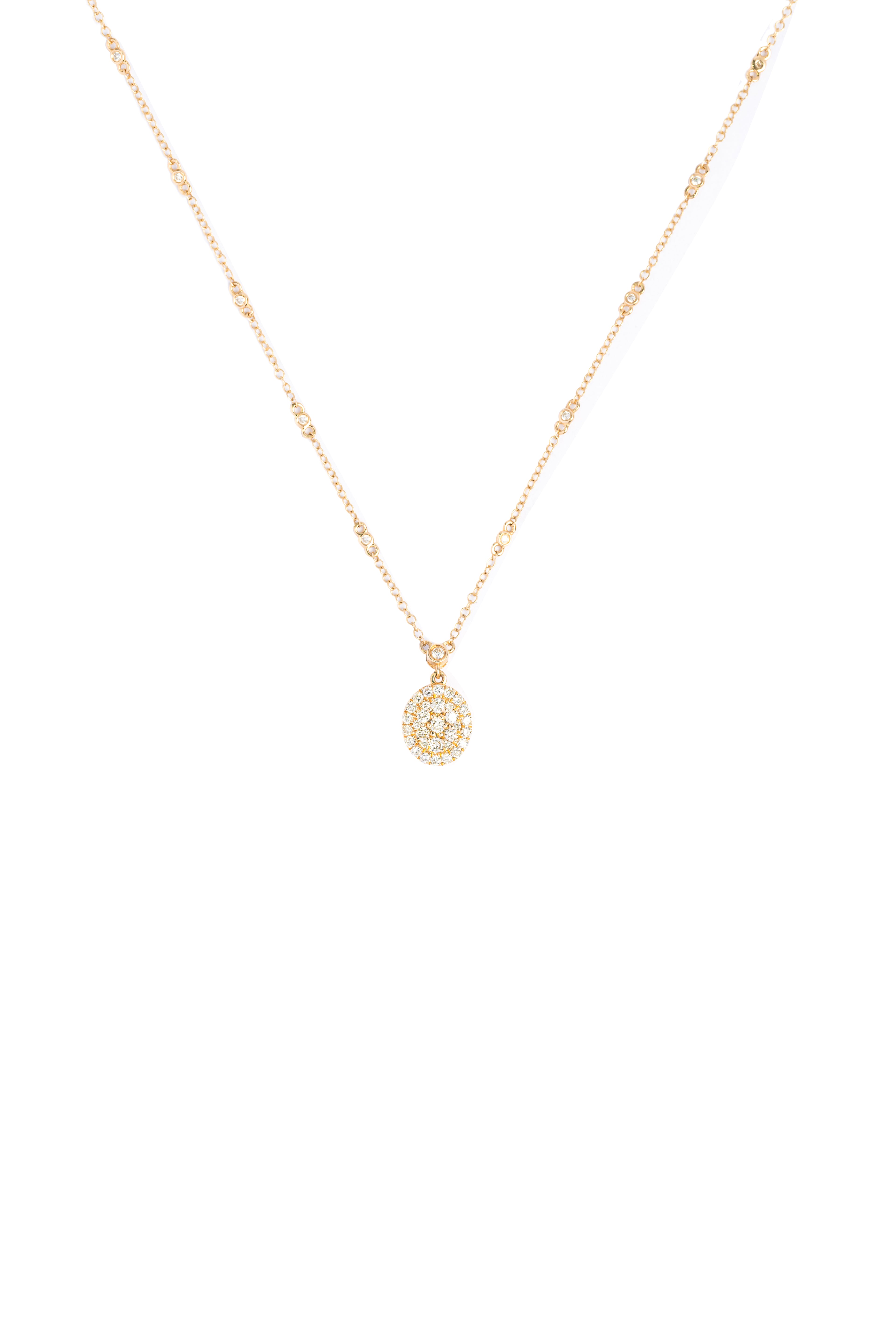 Gold necklace with a small pendant on a white background