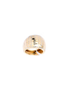 Gold ring with a textured pattern on a white background