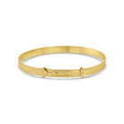 A 14k yellow gold baby bangle bracelet with a heart design.