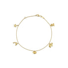 A 14k yellow gold charm anklet with various charms including a heart and a star, displayed against a white background