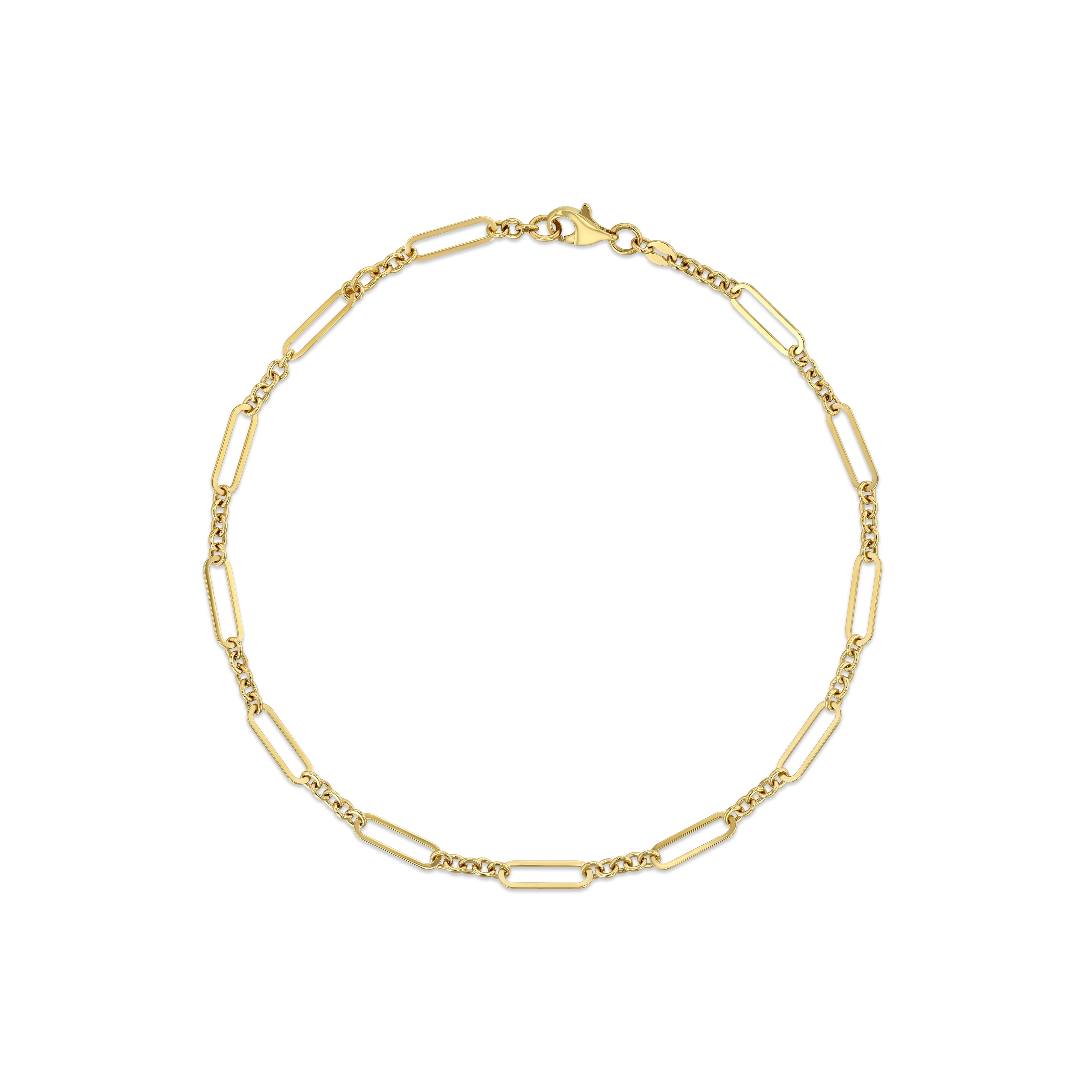 A 14k yellow gold paper clip anklet with a clasp closure.