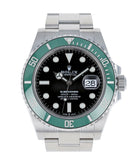 Rolex watch with black face and green bezel on a white background